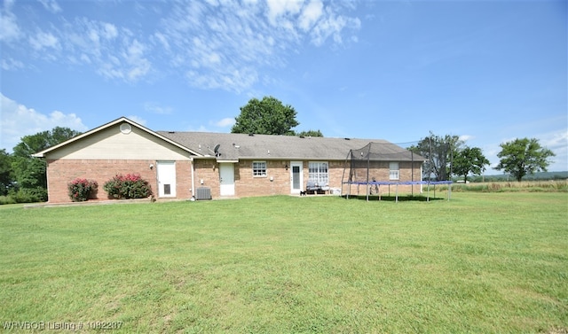 104527 S 4670th Rd, Sallisaw, OK 74955 - view of front of property featuring a front lawn, brick siding, and a trampoline