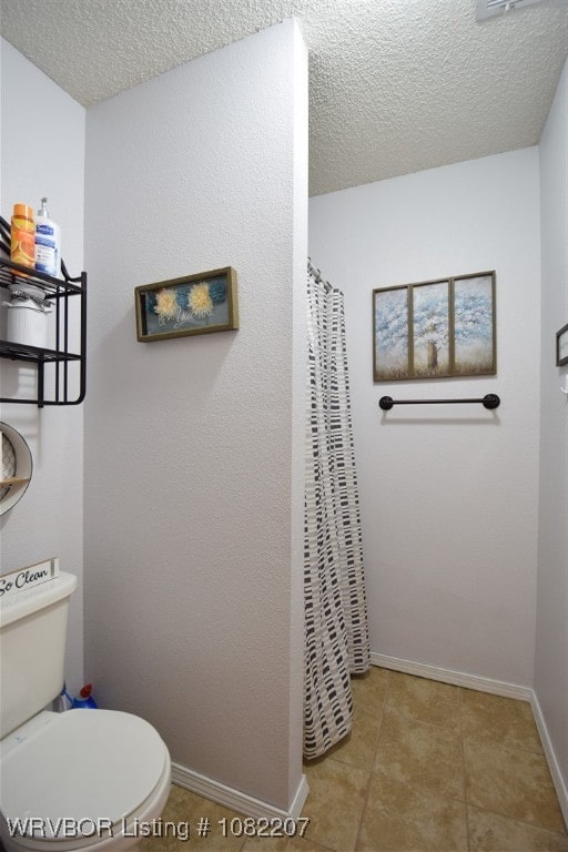 104527 S 4670th Rd, Sallisaw, OK 74955 - bathroom featuring a textured ceiling, a shower with shower curtain, and tile patterned floors