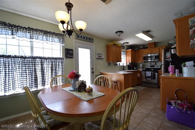 104527 S 4670th Rd, Sallisaw, OK 74955 - dining room with light tile patterned flooring and a textured ceiling