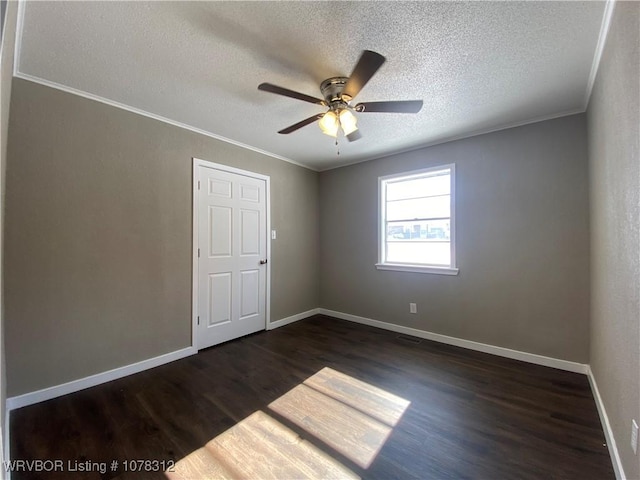 spare room featuring crown molding, ceiling fan, dark hardwood / wood-style flooring, and a textured ceiling