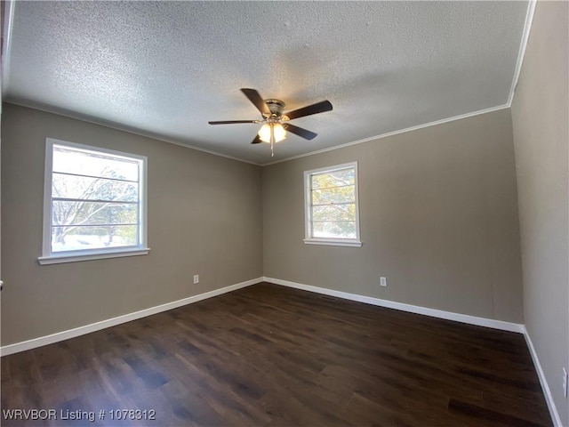 spare room featuring crown molding, a wealth of natural light, ceiling fan, and dark hardwood / wood-style flooring