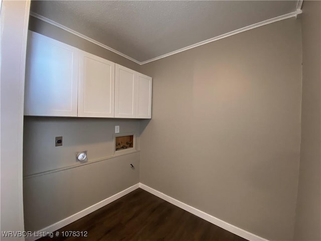 washroom featuring dark hardwood / wood-style floors, cabinets, washer hookup, crown molding, and hookup for an electric dryer