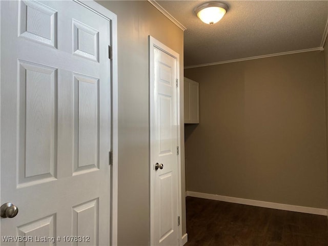 hallway featuring crown molding, dark hardwood / wood-style floors, and a textured ceiling