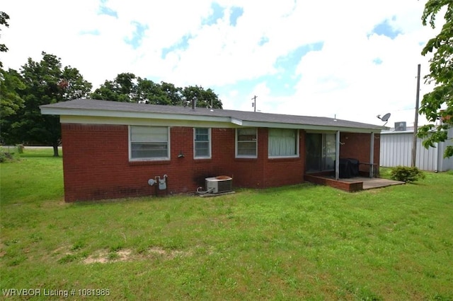 807 S 2nd St, Stilwell, OK 74960 - rear view of house featuring a lawn and brick siding
