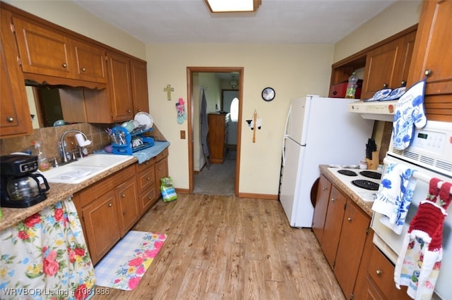 807 S 2nd St, Stilwell, OK 74960 - kitchen with light wood finished floors, brown cabinets, light countertops, tasteful backsplash, and white appliances