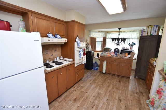 807 S 2nd St, Stilwell, OK 74960 - kitchen with white appliances, light wood-type flooring, brown cabinetry, and under cabinet range hood