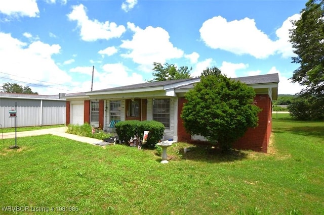 807 S 2nd St, Stilwell, OK 74960 - view of front of house with driveway, a garage, a front yard, and brick siding