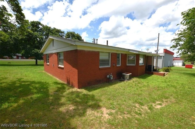 807 S 2nd St, Stilwell, OK 74960 - view of property exterior with brick siding and a lawn