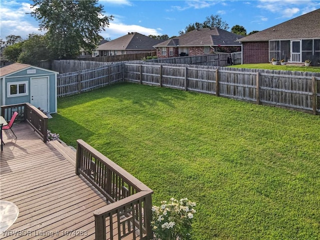 view of yard with a storage shed and a wooden deck