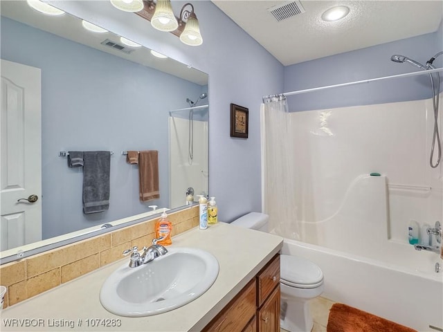 full bathroom with vanity, shower / bath combination with curtain, toilet, and a textured ceiling