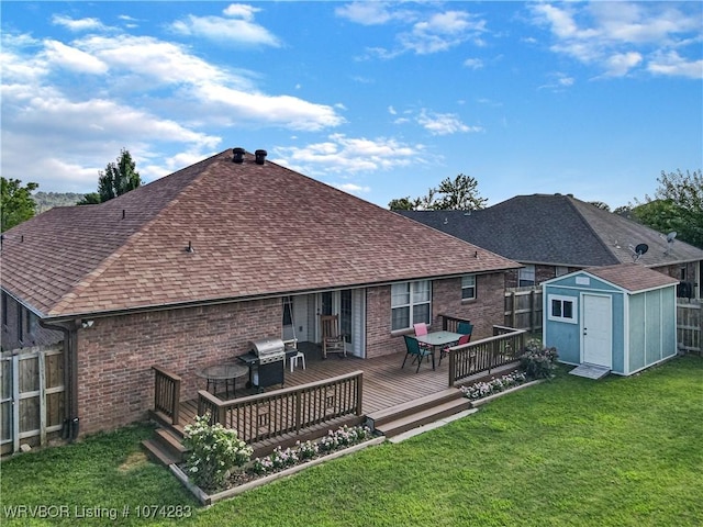 back of house featuring a yard, a deck, and a storage shed