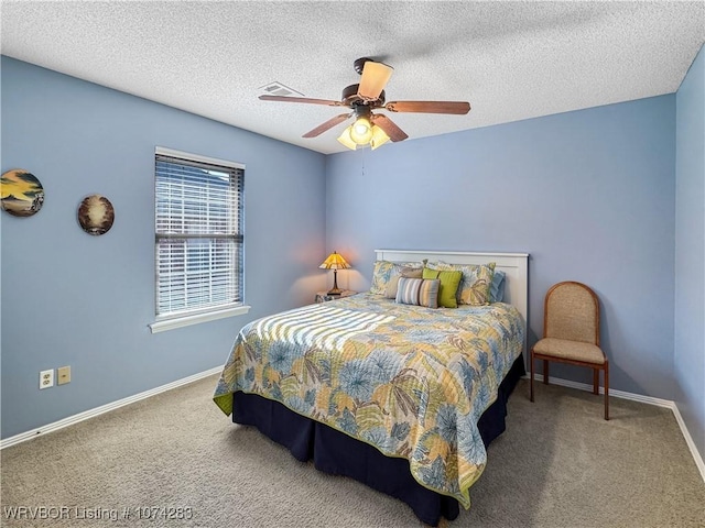 carpeted bedroom with a textured ceiling and ceiling fan