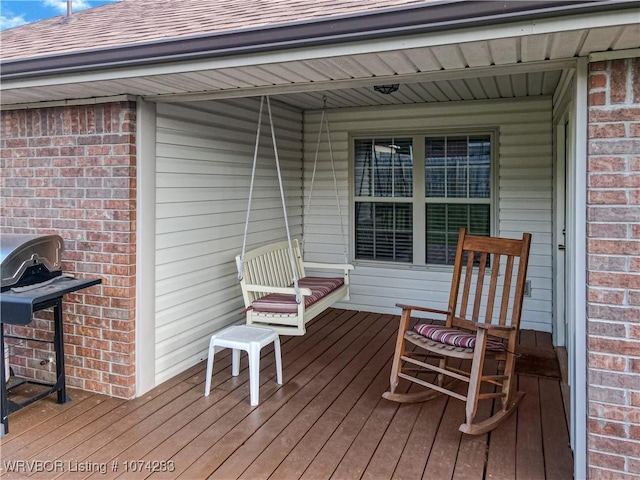 wooden deck featuring a grill