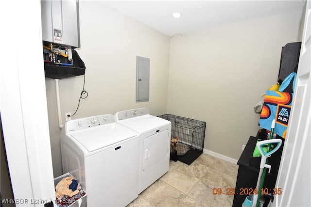 laundry room featuring electric panel and washing machine and clothes dryer