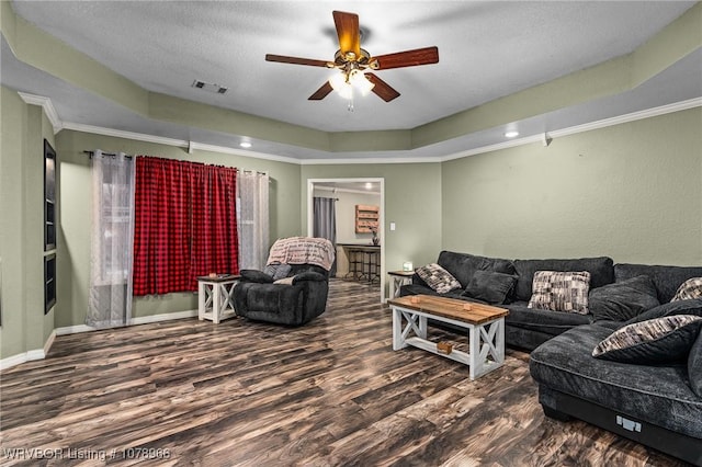 living room with crown molding, a textured ceiling, a tray ceiling, hardwood / wood-style flooring, and ceiling fan