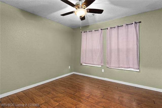 spare room featuring hardwood / wood-style floors and ceiling fan