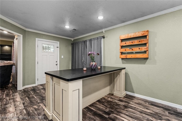 kitchen featuring crown molding, dark hardwood / wood-style floors, a textured ceiling, white cabinets, and kitchen peninsula