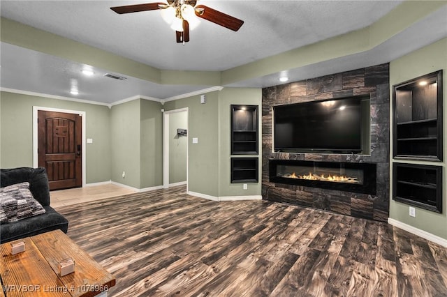 living room featuring ornamental molding, hardwood / wood-style floors, and a textured ceiling