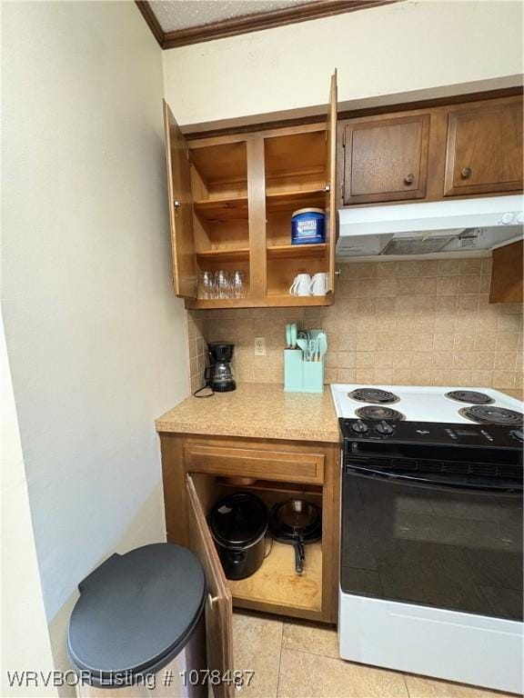 kitchen with tasteful backsplash, ornamental molding, electric range oven, and light tile patterned floors