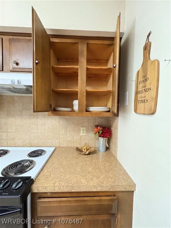 kitchen featuring tasteful backsplash, black range with electric stovetop, and extractor fan