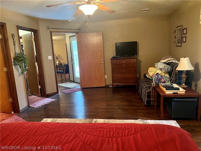 bedroom with ceiling fan and dark hardwood / wood-style flooring