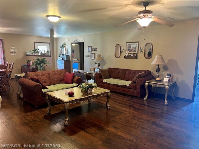 living room with dark hardwood / wood-style flooring and ceiling fan