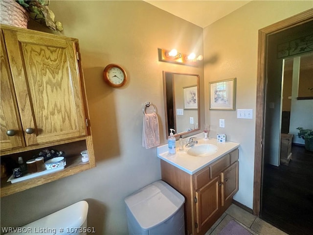 bathroom featuring tile patterned flooring, vanity, and toilet