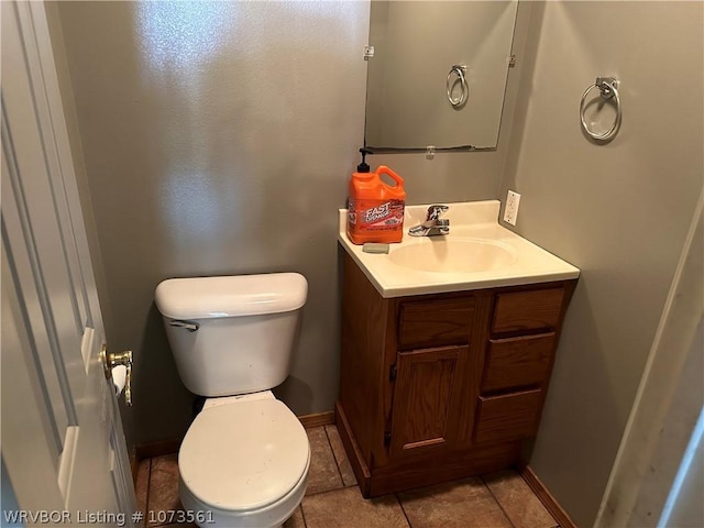 bathroom featuring tile patterned floors, vanity, and toilet