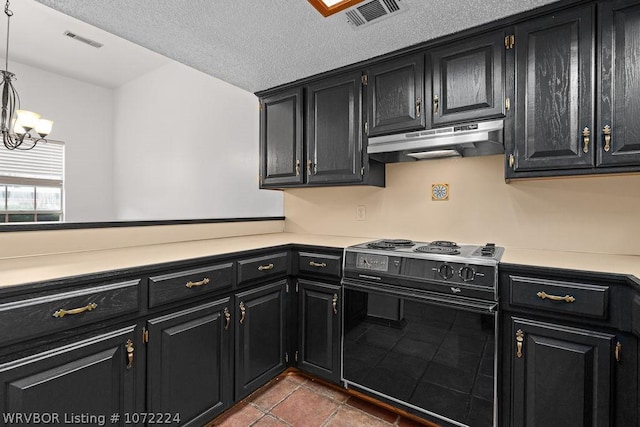 kitchen with light countertops, under cabinet range hood, electric range, visible vents, and dark cabinets