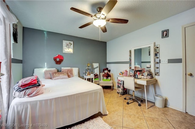 bedroom with ceiling fan and light tile patterned floors