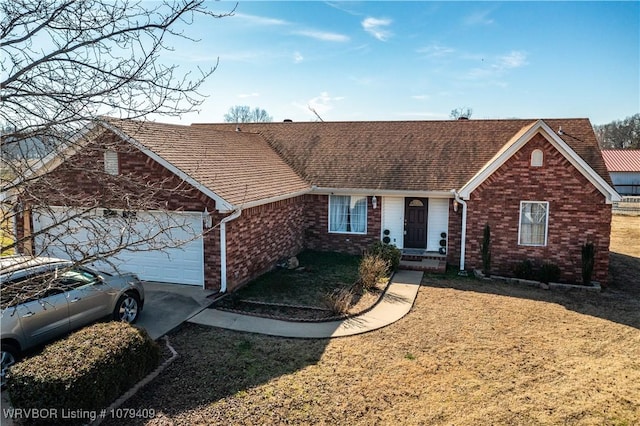 single story home with a garage, roof with shingles, brick siding, and a front lawn