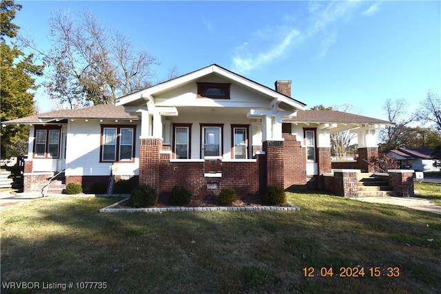 view of front facade with covered porch and a front lawn