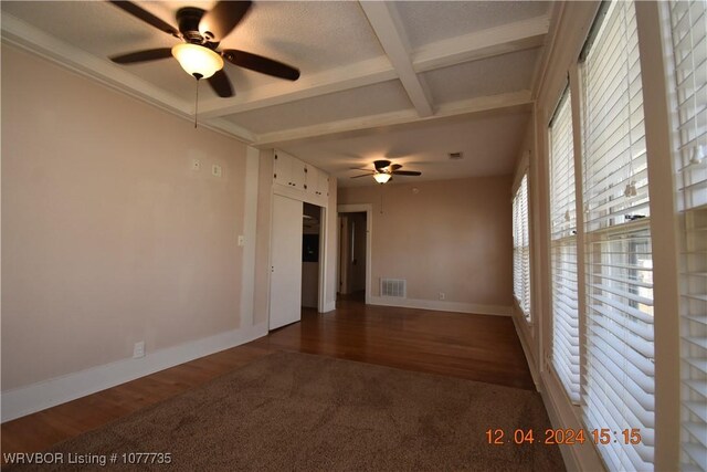 spare room featuring beam ceiling, dark hardwood / wood-style floors, ceiling fan, and coffered ceiling