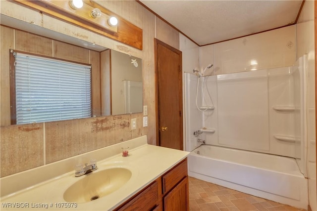 bathroom with vanity, wood walls, shower / tub combination, and a textured ceiling