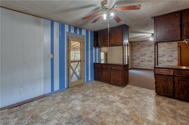 kitchen with dark brown cabinetry, ceiling fan, and a textured ceiling