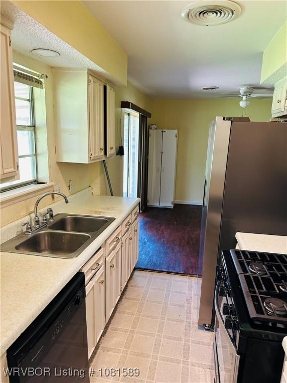 1301 9th St, Barling, AR 72923 - kitchen featuring dishwasher, gas range, a sink, and light countertops