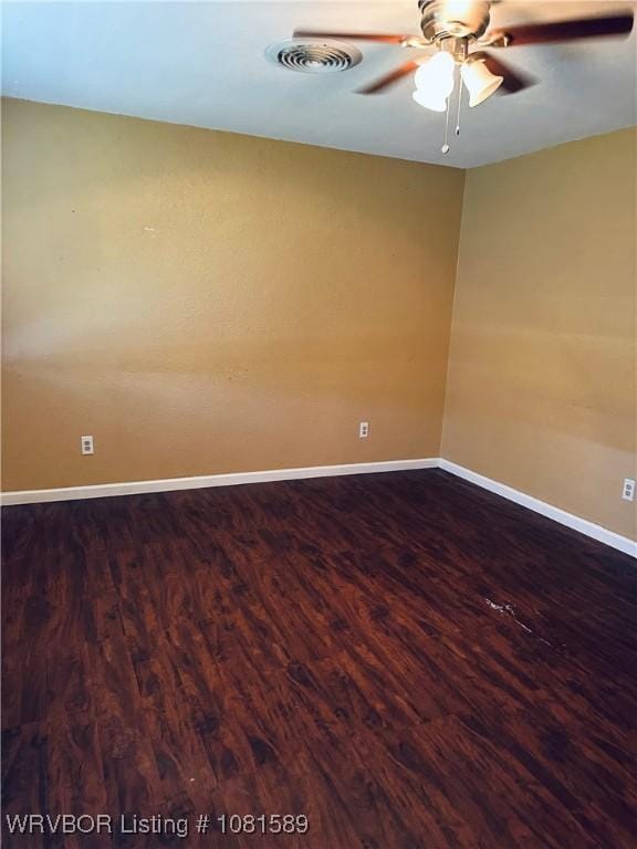 1301 9th St, Barling, AR 72923 - empty room with dark wood-type flooring, ceiling fan, and baseboards