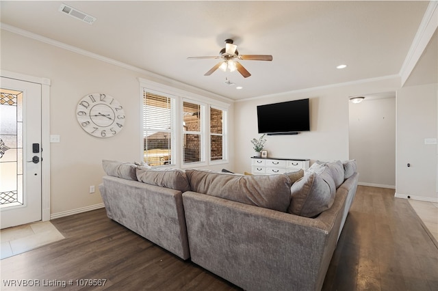 living area featuring visible vents, wood finished floors, crown molding, baseboards, and ceiling fan