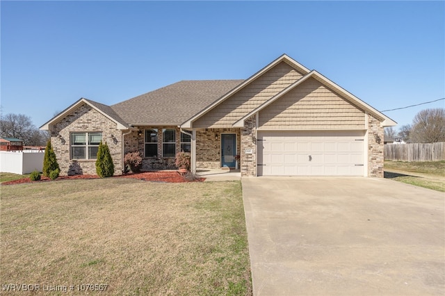 view of front of home featuring a front yard, fence, an attached garage, concrete driveway, and brick siding