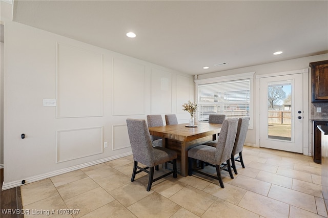 dining area with recessed lighting, visible vents, light tile patterned floors, and a decorative wall