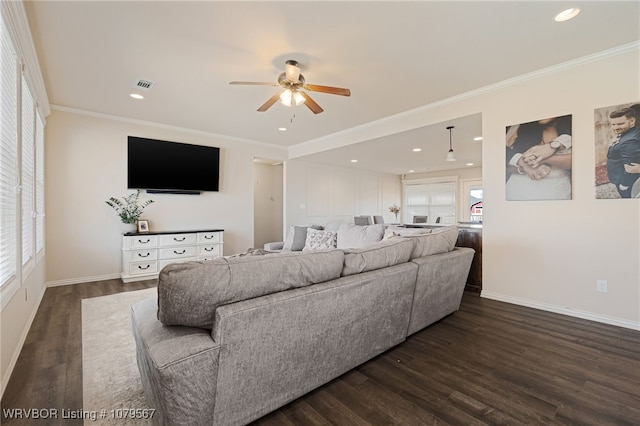 living area featuring dark wood finished floors, crown molding, and visible vents