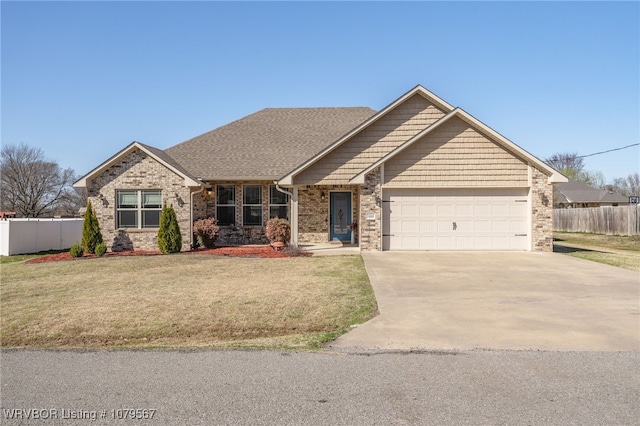 view of front of house featuring a front lawn, fence, a garage, and driveway