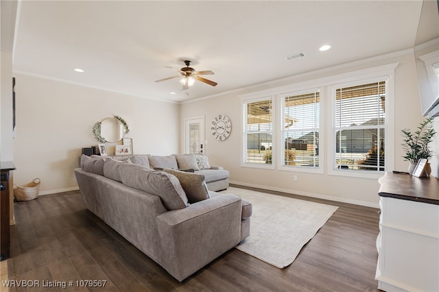 living room featuring visible vents, crown molding, and dark wood-type flooring