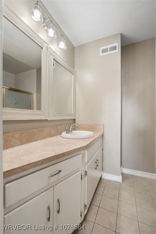 bathroom featuring tile patterned flooring and vanity