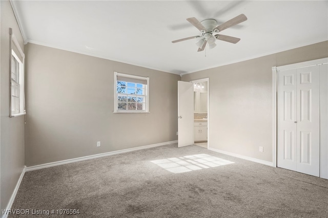 unfurnished bedroom with light carpet, ensuite bath, ceiling fan, and ornamental molding