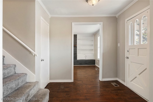 entrance foyer featuring plenty of natural light, dark hardwood / wood-style flooring, and ornamental molding