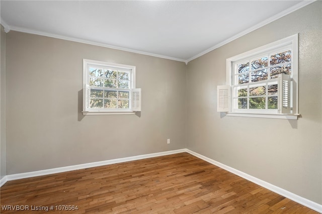 unfurnished room featuring crown molding and hardwood / wood-style flooring