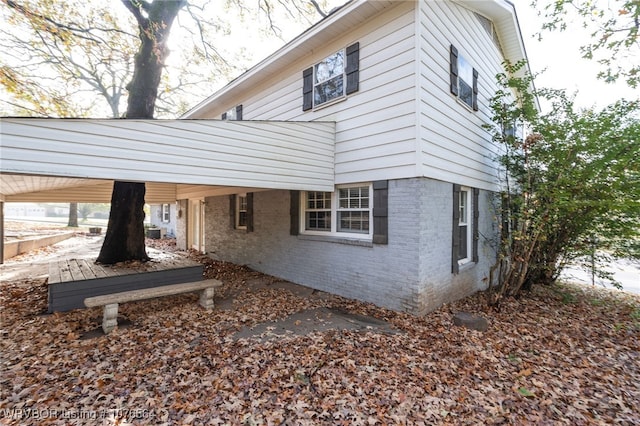 view of property exterior featuring a carport