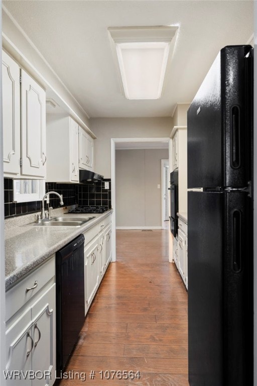 kitchen with black appliances, sink, decorative backsplash, dark hardwood / wood-style flooring, and white cabinetry