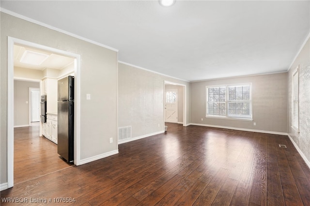 empty room with dark wood-type flooring and crown molding